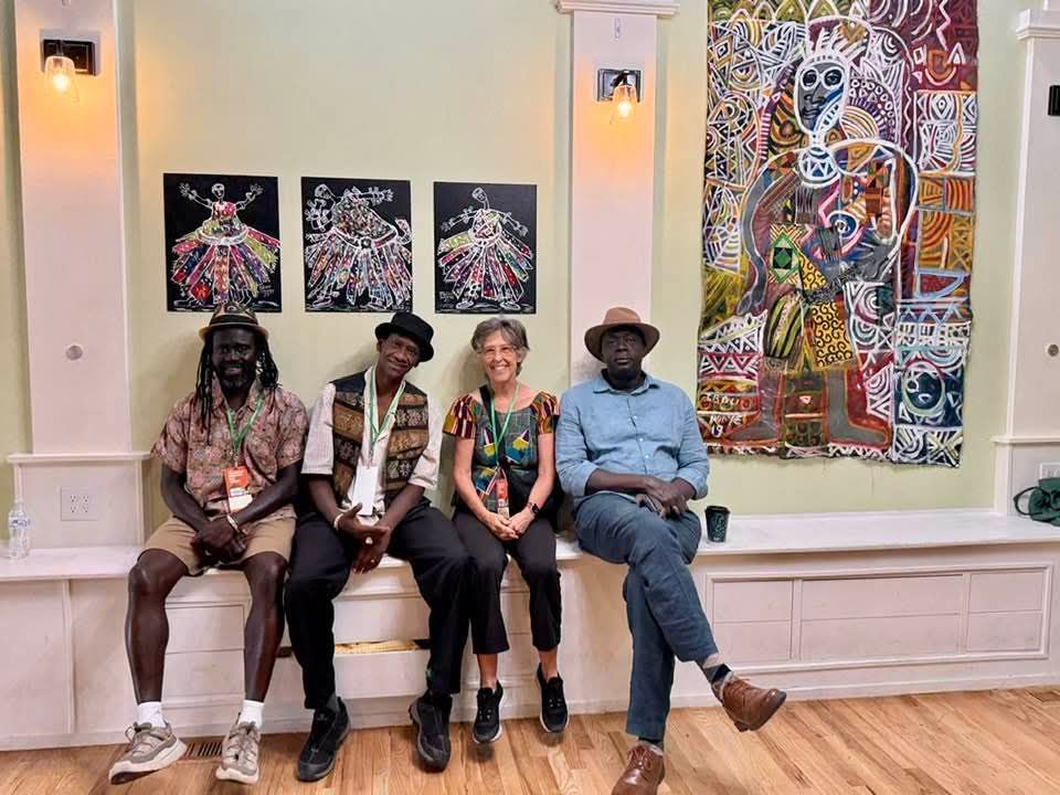 Artists in front of the exhibition wall